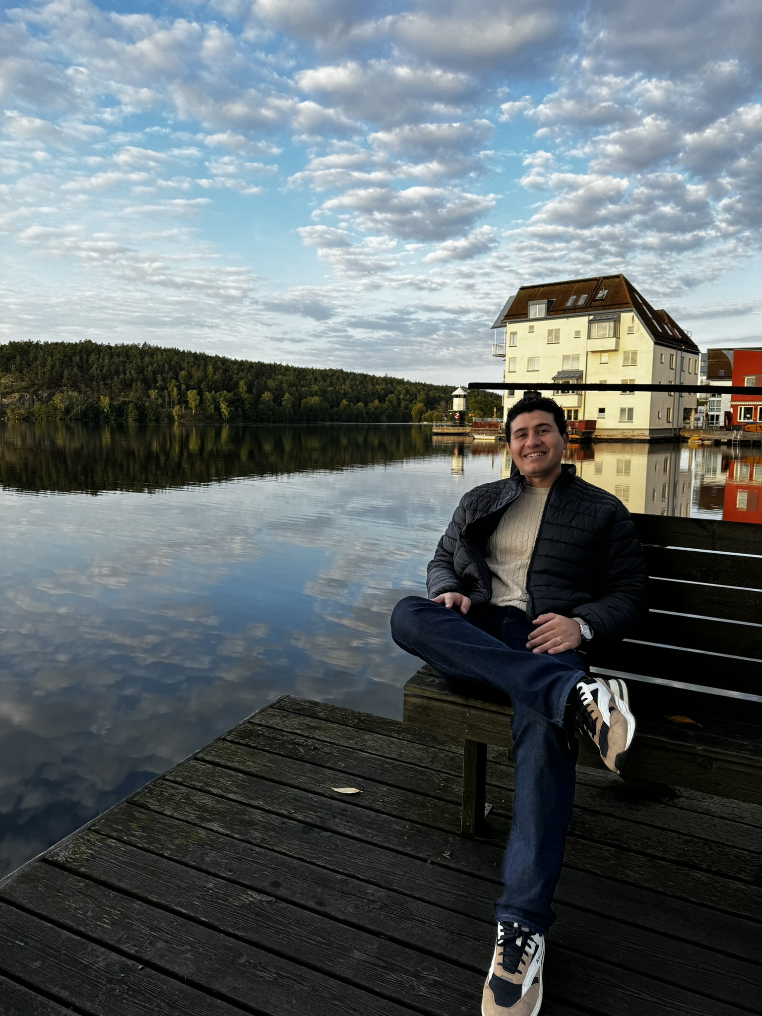 Sherif Ayman sitting on a jetty by a lake